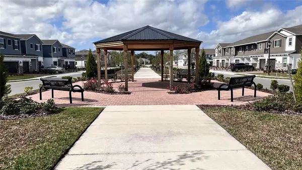 a view of a house with backyard porch and sitting area