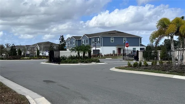 a view of a street with a houses in the background