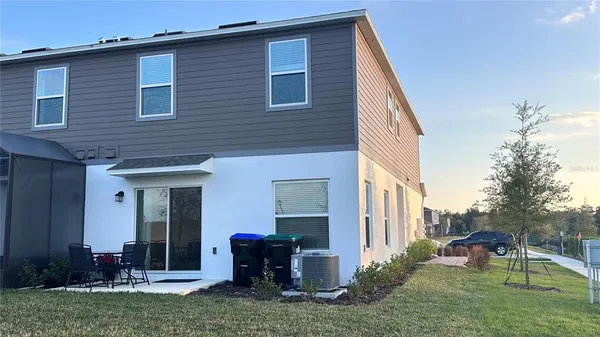 a view of a house with backyard porch and sitting area