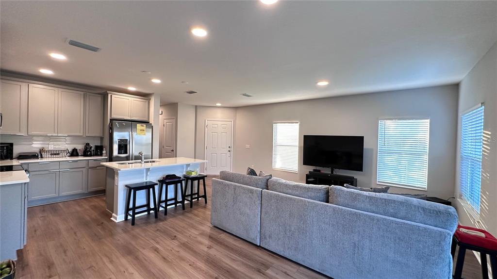 4424 Campsite Loop Orlando, FL 32824 - Photo 10 of 40 a living room with furniture and a flat screen tv