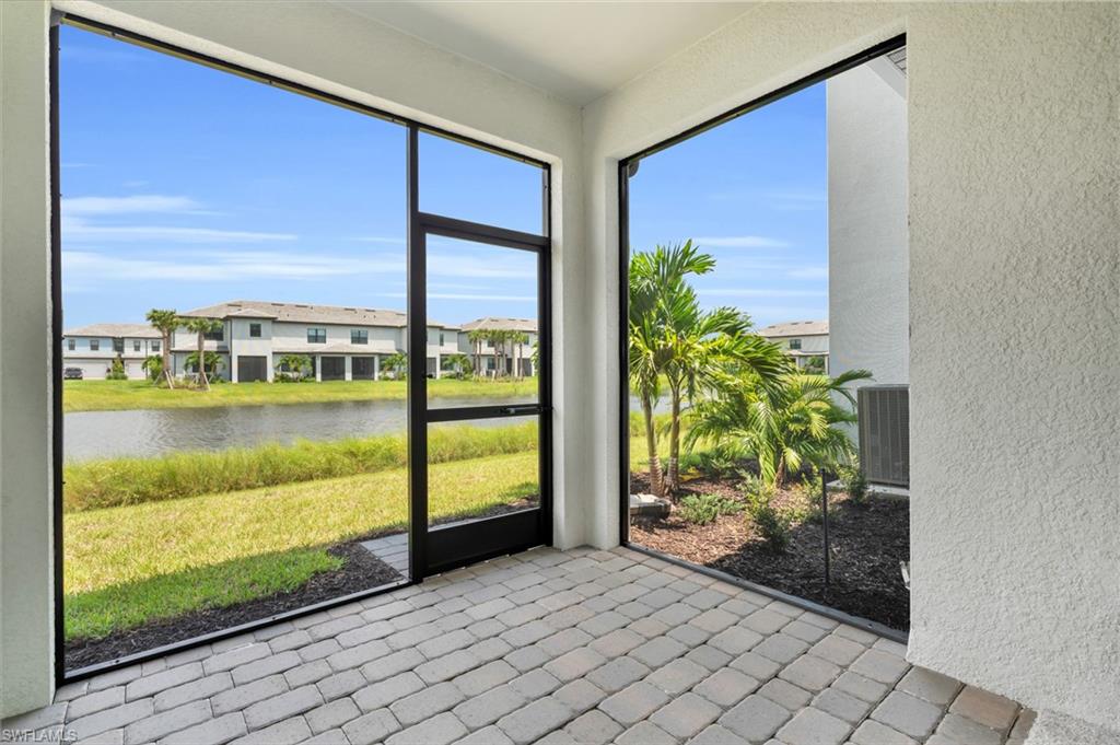 Unfurnished sunroom with a residential view and a water view