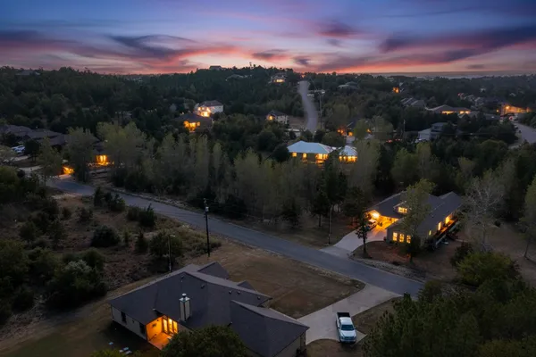 an aerial view of a house with a yard