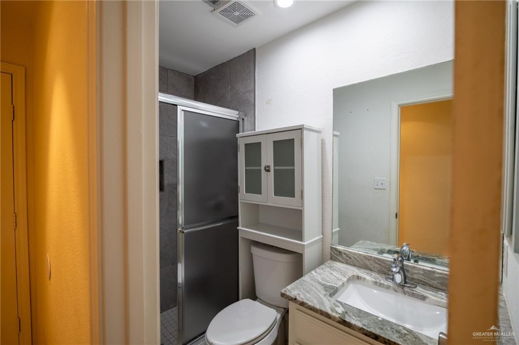 1901 Duke Avenue McAllen, TX 78504 - Photo 20 of 44 Bathroom featuring vanity, an enclosed shower, and toilet