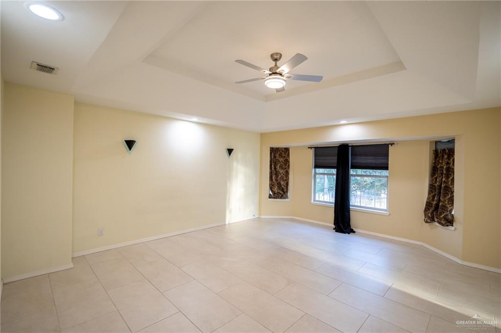 1901 Duke Avenue McAllen, TX 78504 - Photo 23 of 44 Spare room featuring a raised ceiling and ceiling fan