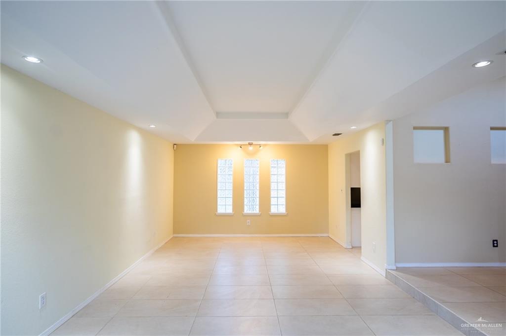 1901 Duke Avenue McAllen, TX 78504 - Photo 6 of 44 Empty room with light tile patterned floors and a tray ceiling