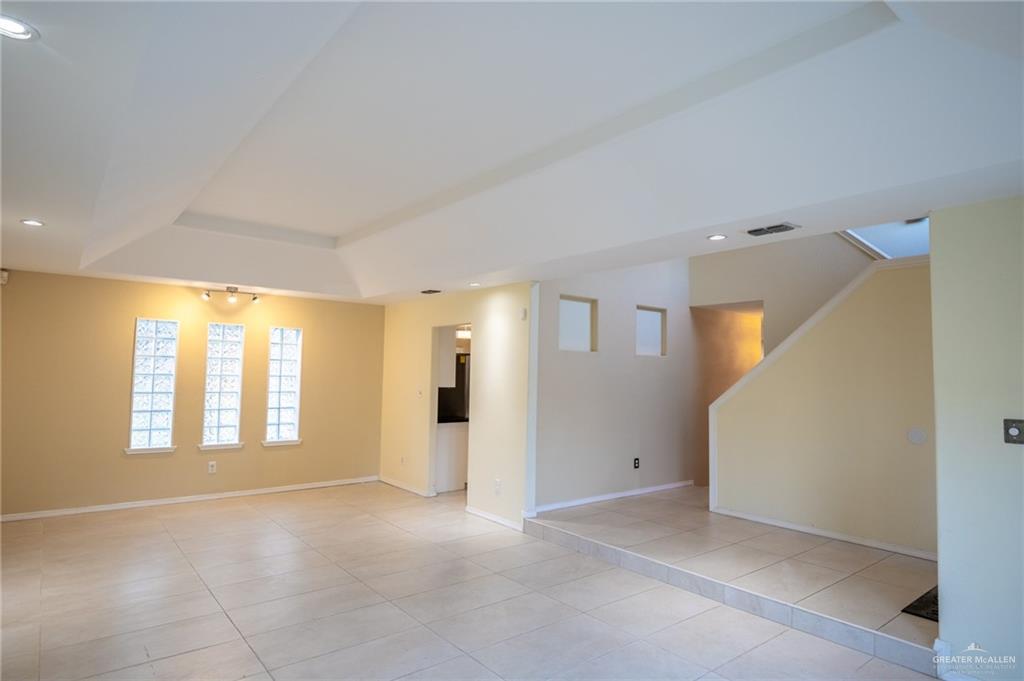 1901 Duke Avenue McAllen, TX 78504 - Photo 7 of 44 Unfurnished room featuring light tile patterned floors and a tray ceiling