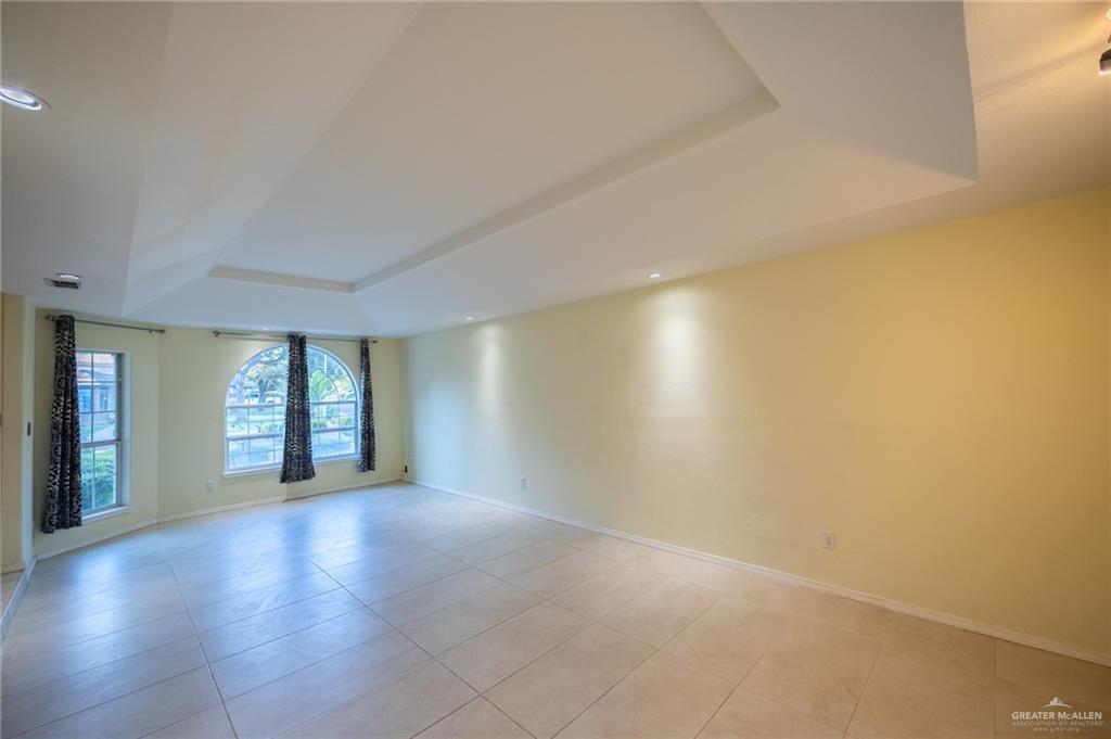 1901 Duke Avenue McAllen, TX 78504 - Photo 10 of 44 Spare room with a tray ceiling and light tile patterned floors