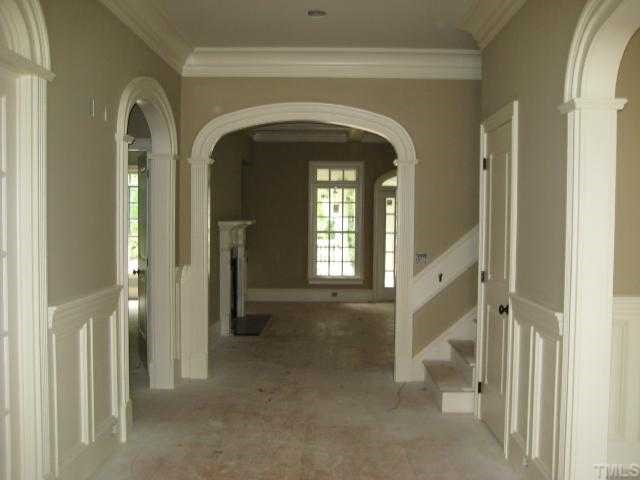 3231 Rain Forrest Way Raleigh, NC 27614 - Photo 2 of 6 This is the generously sized foyer. Please note the wainscoting, arched doorways and trim! The view is from the front of the home to the Family Room at back. Formal Dining Room is on the right and the Library is on the left.