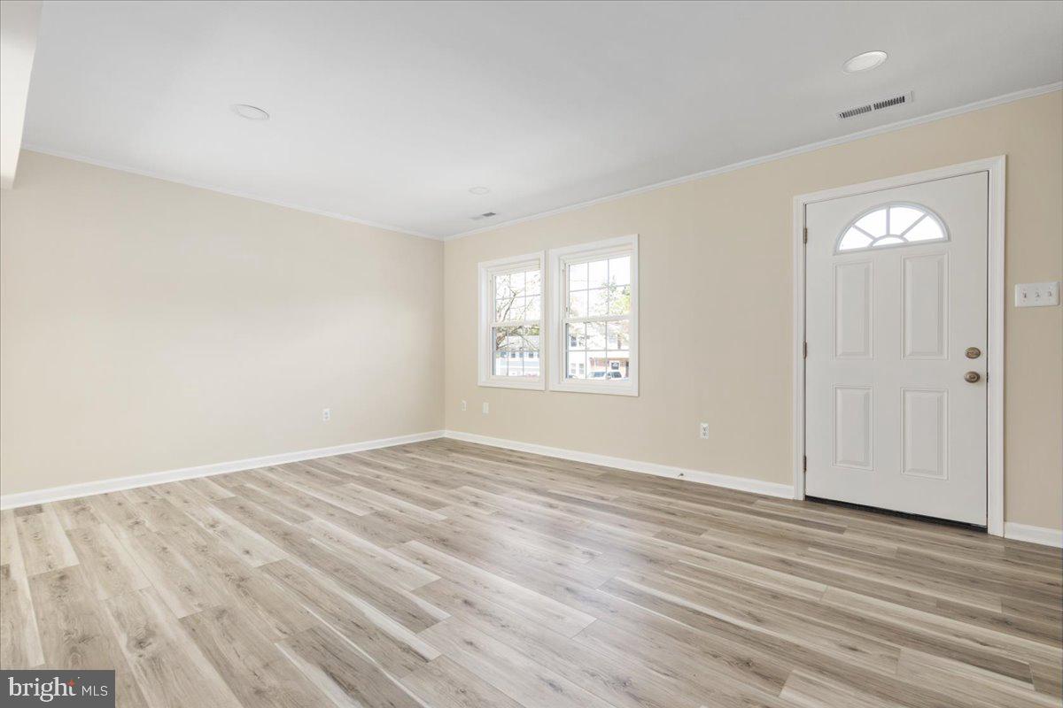 1811 Picadilly Circus Culpeper, VA 22701 - Photo 5 of 16 an empty room with wooden floor and windows