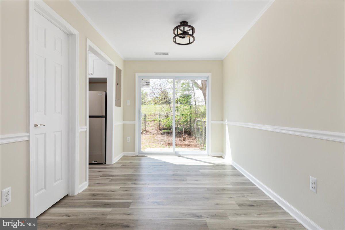 1811 Picadilly Circus Culpeper, VA 22701 - Photo 7 of 16 a view of an empty room with wooden floor and a window
