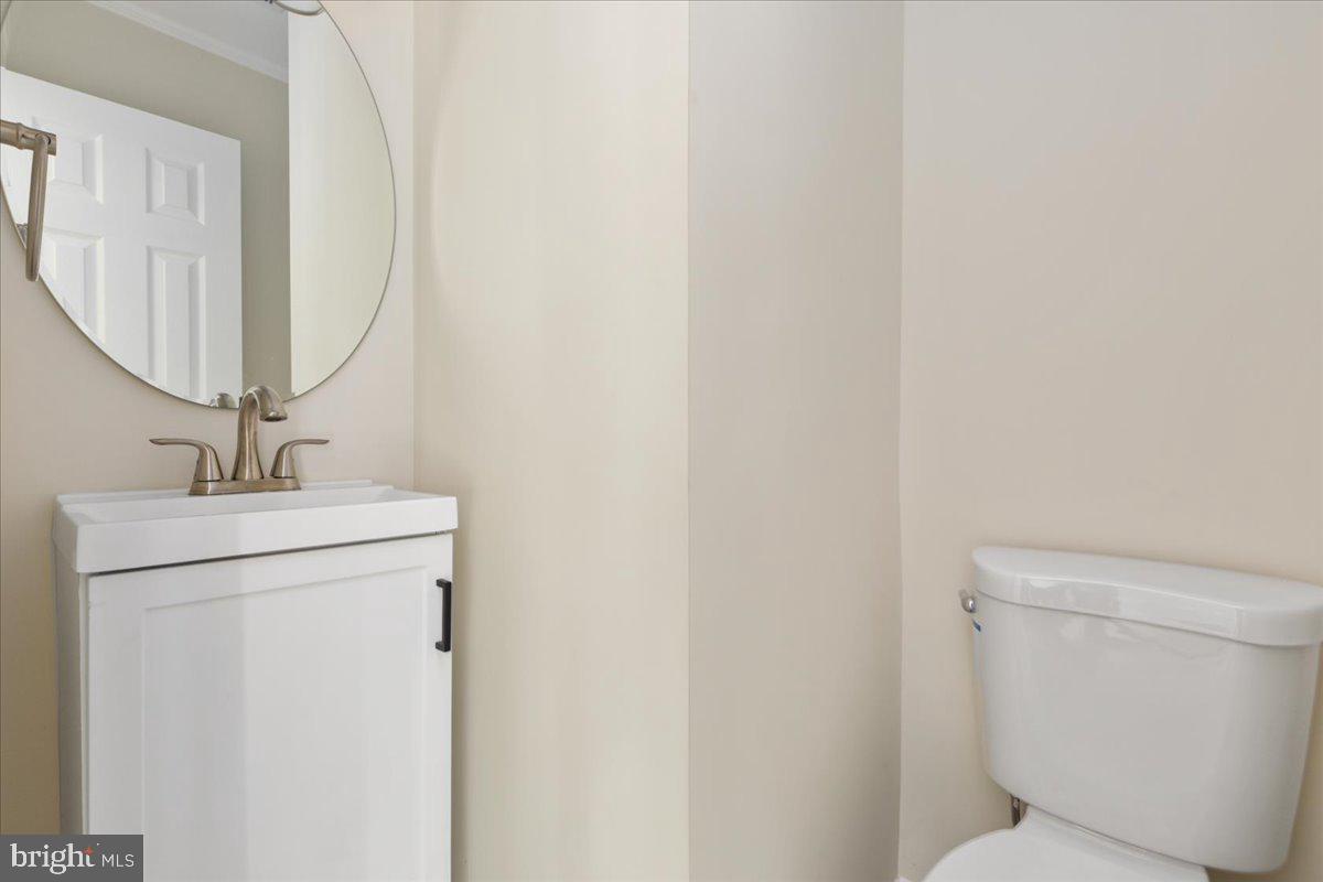 1811 Picadilly Circus Culpeper, VA 22701 - Photo 9 of 16 a bathroom with a toilet sink and mirror