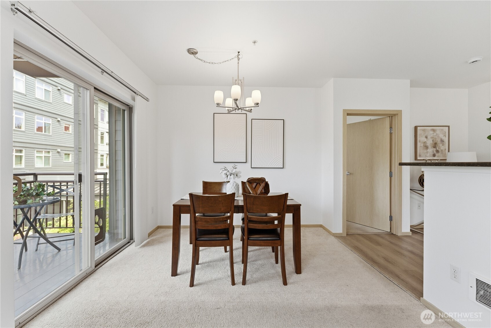 3333 Wallingford Avenue North, Unit 203 Seattle, WA 98103 - Photo 15 of 37 a view of a dining room with furniture and a chandelier