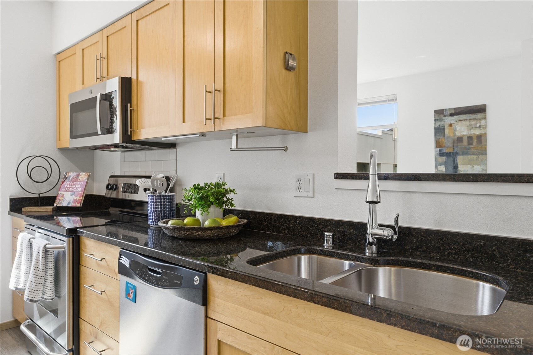 3333 Wallingford Avenue North, Unit 203 Seattle, WA 98103 - Photo 16 of 37 a kitchen with granite countertop a sink stainless steel appliances and cabinets