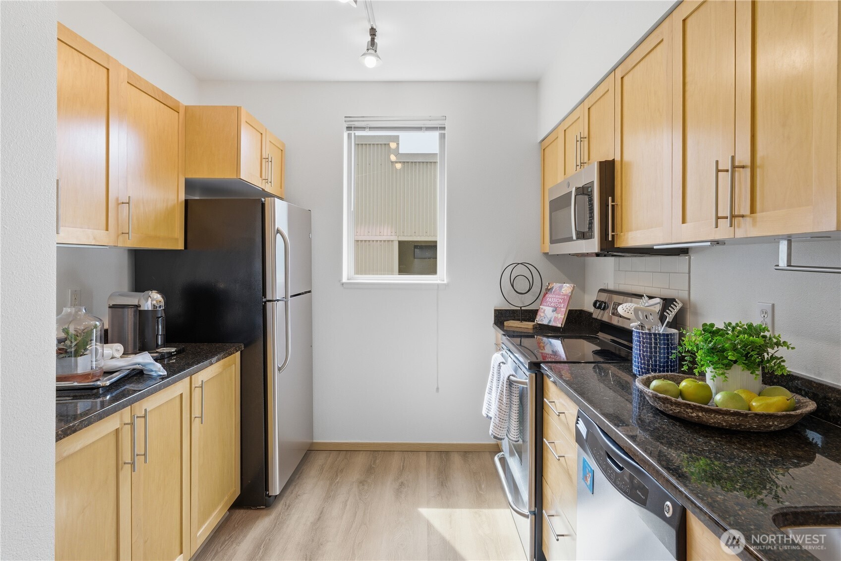 3333 Wallingford Avenue North, Unit 203 Seattle, WA 98103 - Photo 17 of 37 a kitchen with stainless steel appliances granite countertop a stove a refrigerator and a sink