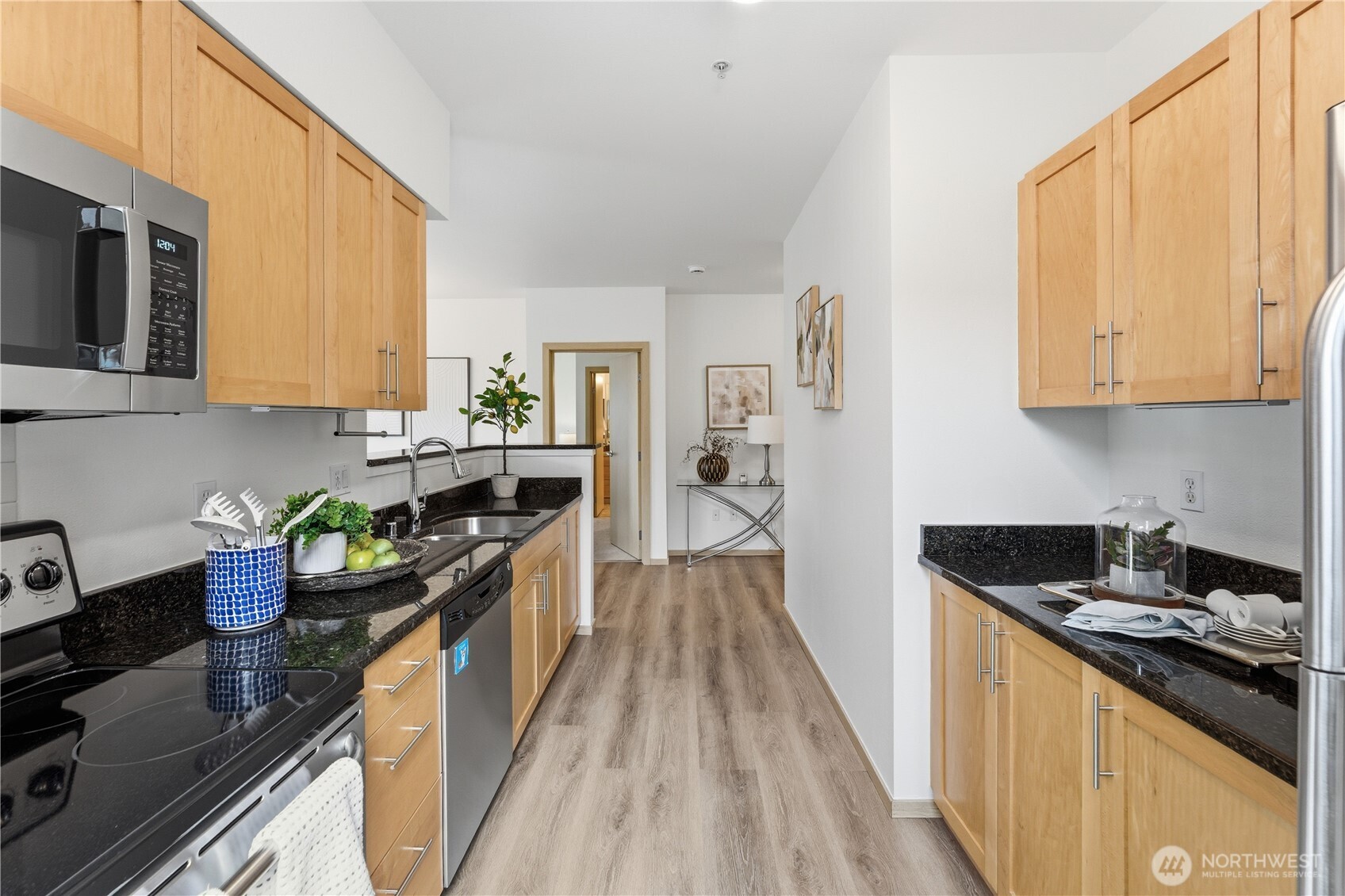 3333 Wallingford Avenue North, Unit 203 Seattle, WA 98103 - Photo 19 of 37 a kitchen with stainless steel appliances granite countertop a stove a sink and a microwave