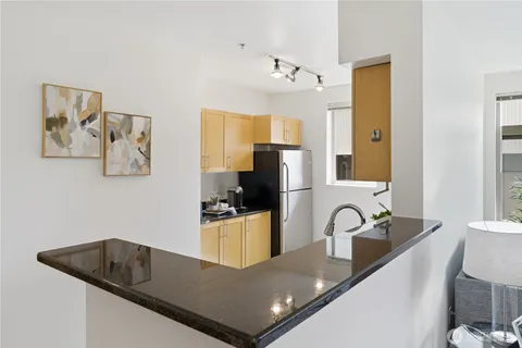 a kitchen with a refrigerator and a sink