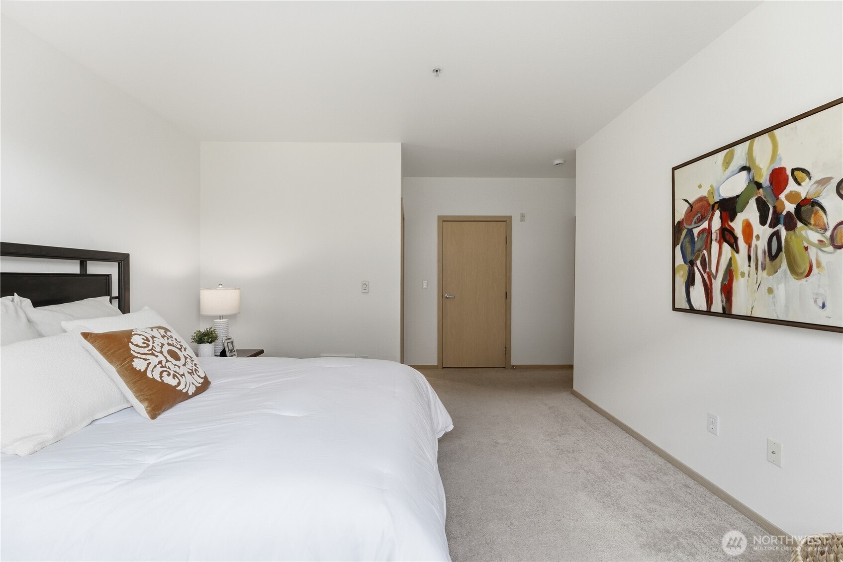 3333 Wallingford Avenue North, Unit 203 Seattle, WA 98103 - Photo 24 of 37 a bedroom with a bed and painting on the wall