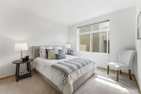 a bedroom with a bed and a chair