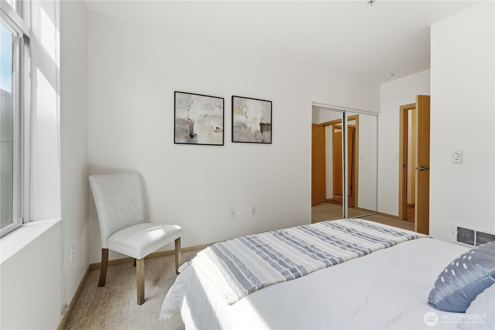 3333 Wallingford Avenue North, Unit 203 Seattle, WA 98103 - Photo 30 of 37 a bedroom with a bed and furniture