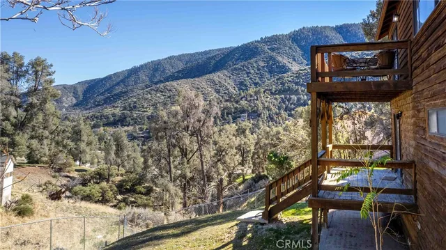 a view of a kitchen with wooden floor and a refrigerator