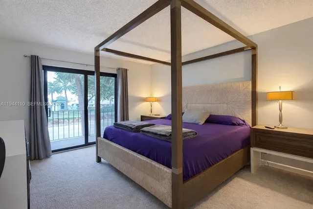 a bedroom with a bed and large window