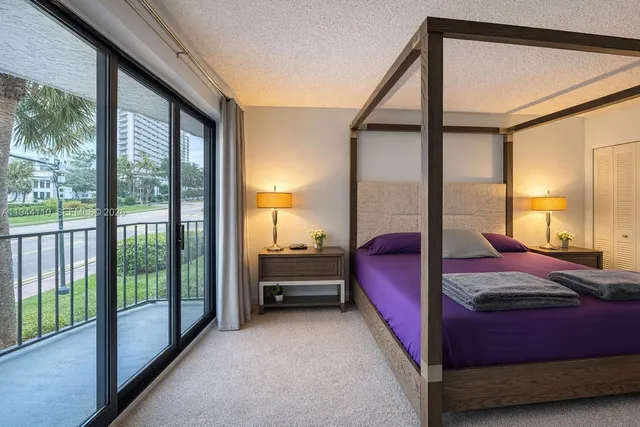 a bed room with a bed and a large window