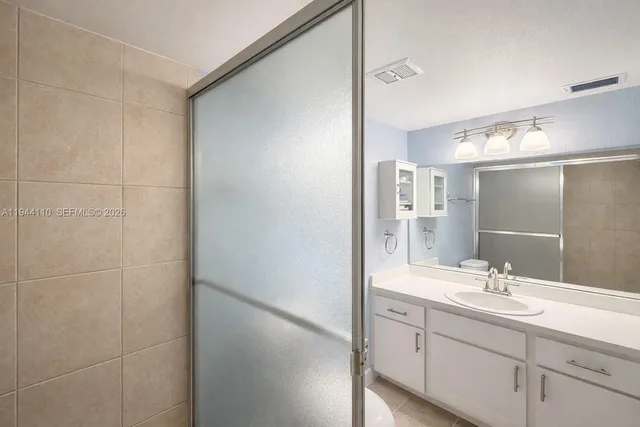 a bathroom with a double vanity sink and a mirror