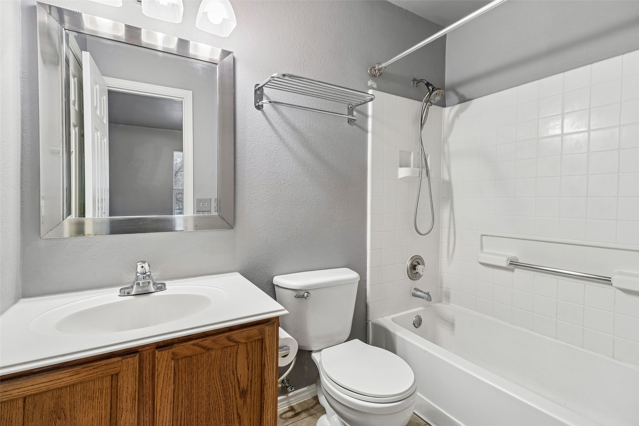 311 A Utterback Kyle, TX 78640 - Photo 25 of 40 a bathroom with a granite countertop sink toilet and shower