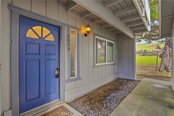 a view of front door with wooden door