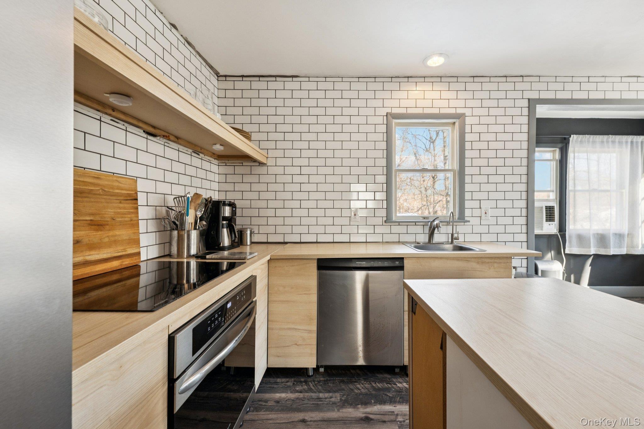 a kitchen with stainless steel appliances granite countertop a sink and wooden cabinets