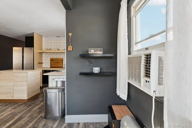 a kitchen with granite countertop stainless steel appliances a sink stove and refrigerator