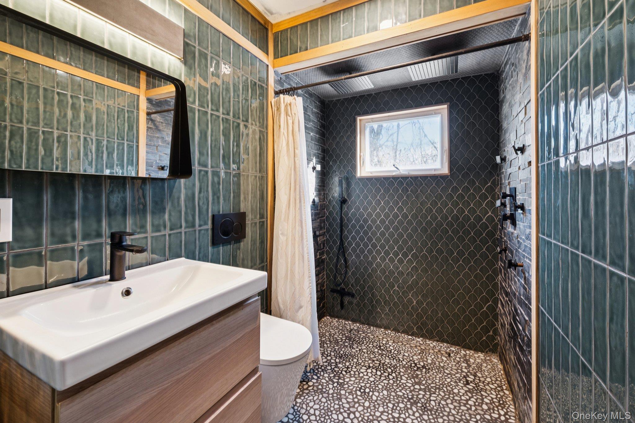 176 Maple Avenue South Flanders, NY 11901 - Photo 19 of 40 a bathroom with a sink a toilet a mirror and shower