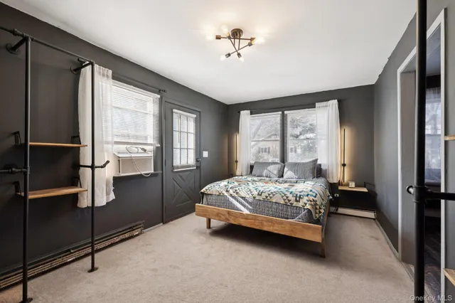 a spacious bedroom with a bed and a chandelier