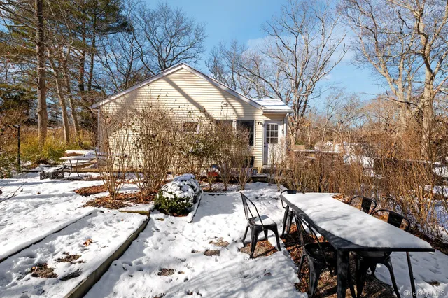 a view of white house with a snow in the background