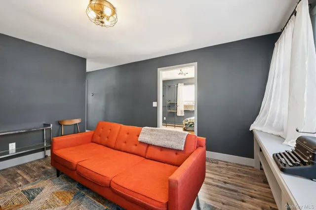 a blue bed sitting in a bedroom next to a window