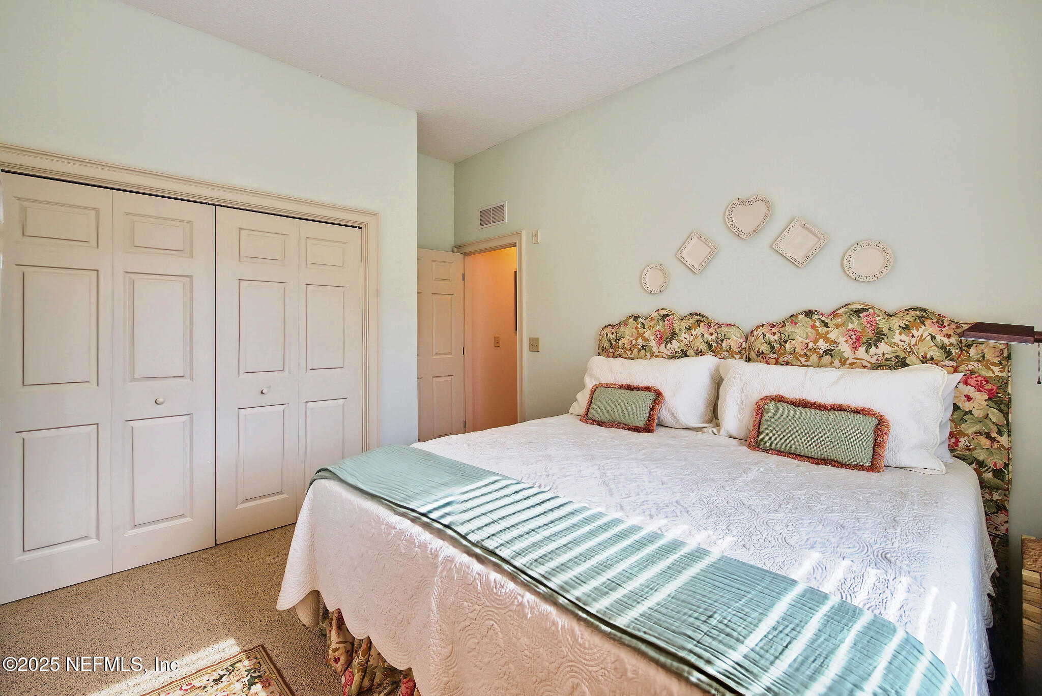 1 Radio Road, Unit 203 St. Augustine, FL 32084 - Photo 29 of 57 a bedroom with a bed and a table in it