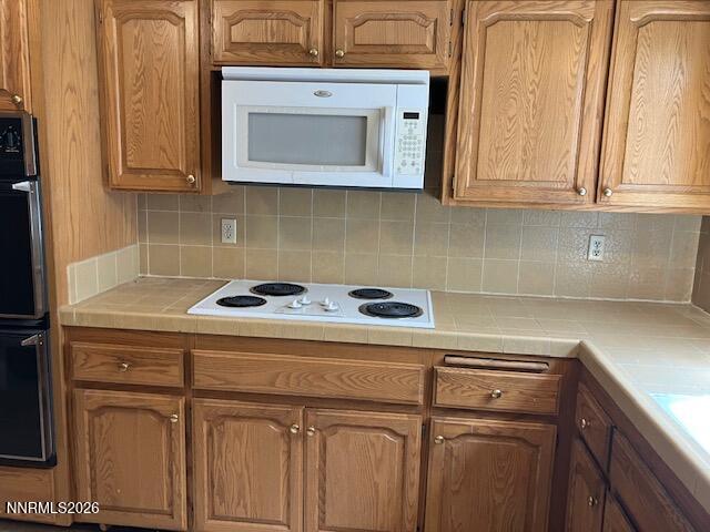 840 Meadow Springs Drive Reno, NV 89509 - Photo 3 of 23 a kitchen with stainless steel appliances granite countertop white cabinets and a stove top oven