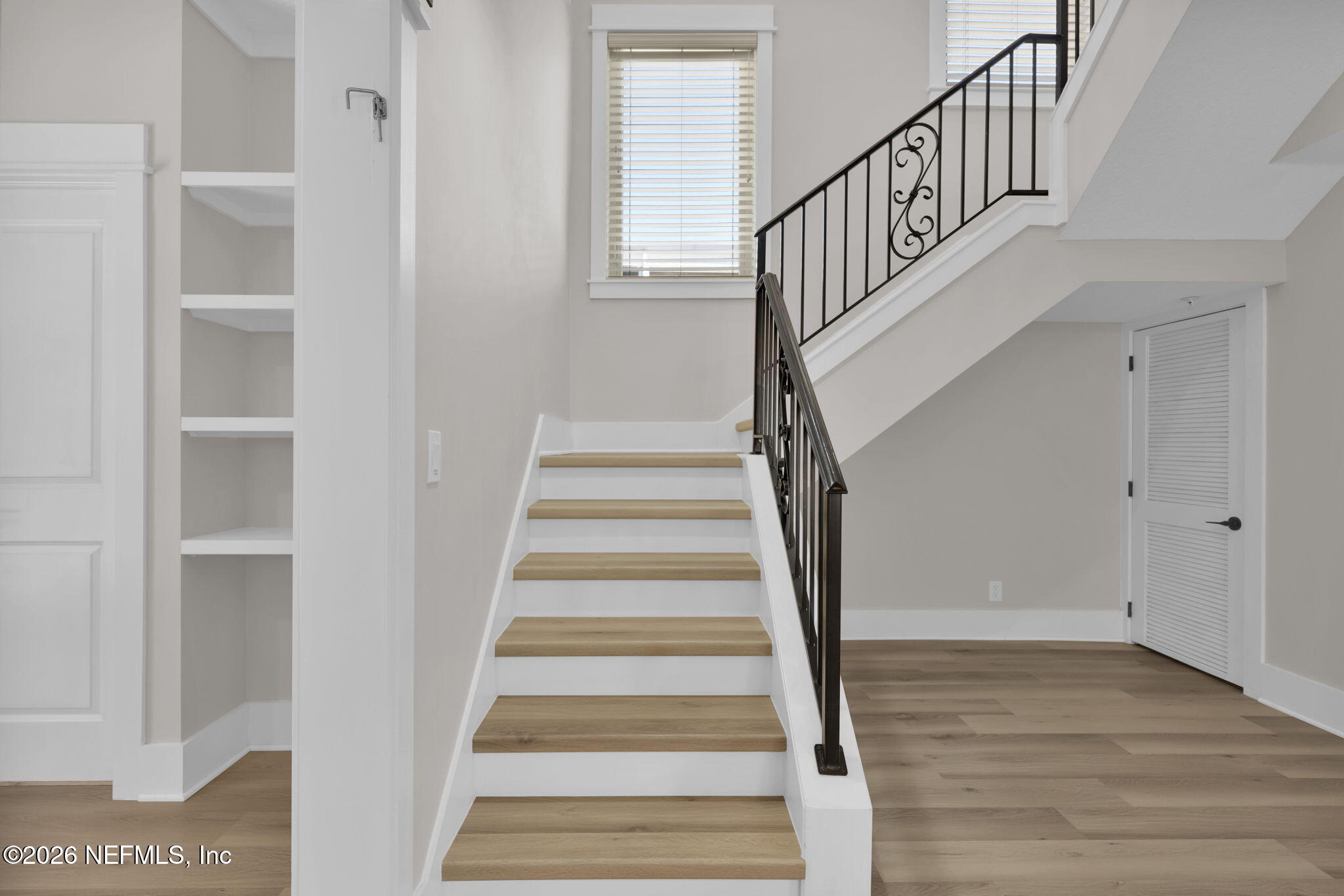 339 Ahern Street, Unit 4 Atlantic Beach, FL 32233 - Photo 20 of 47 a view of staircase with wooden floor and white walls