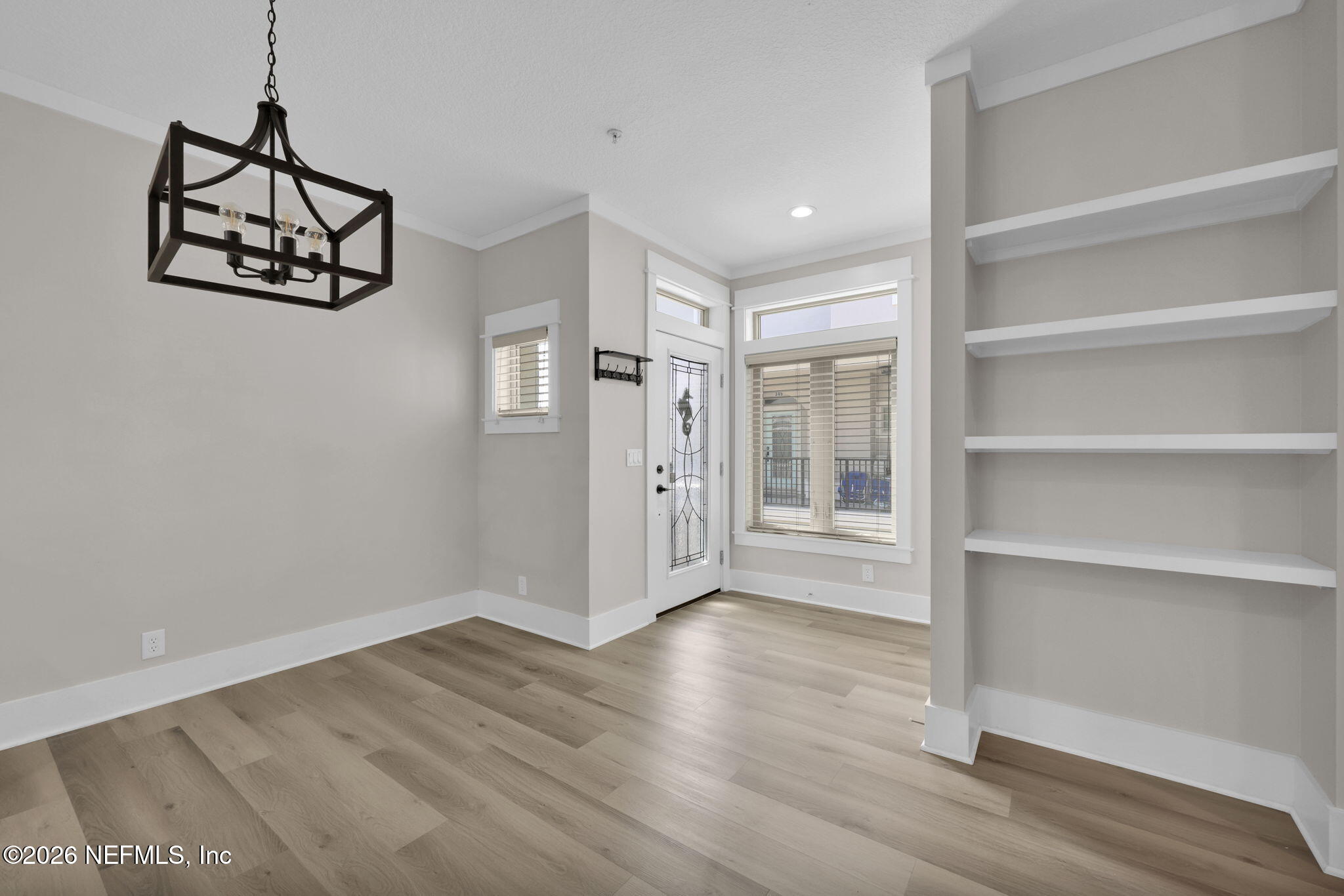 339 Ahern Street, Unit 4 Atlantic Beach, FL 32233 - Photo 6 of 47 a view of a room with wooden floor and closet
