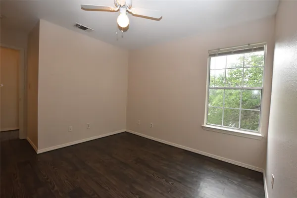 a view of a room with wooden floor and windows