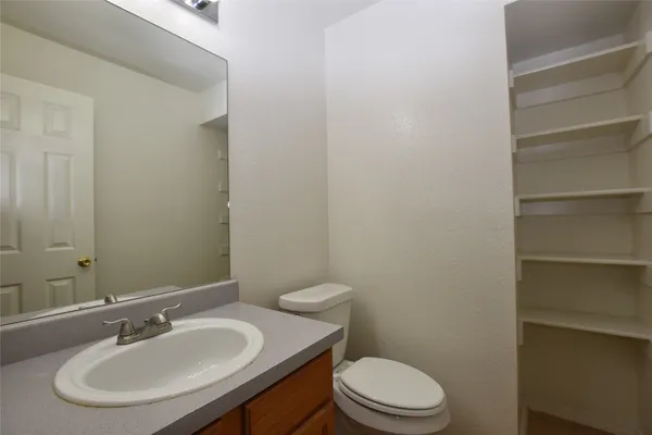 a bathroom with a sink a toilet and a mirror
