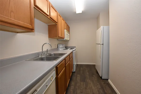 a kitchen with sink a refrigerator and cabinets