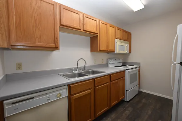 a kitchen with stainless steel appliances granite countertop a sink and cabinets