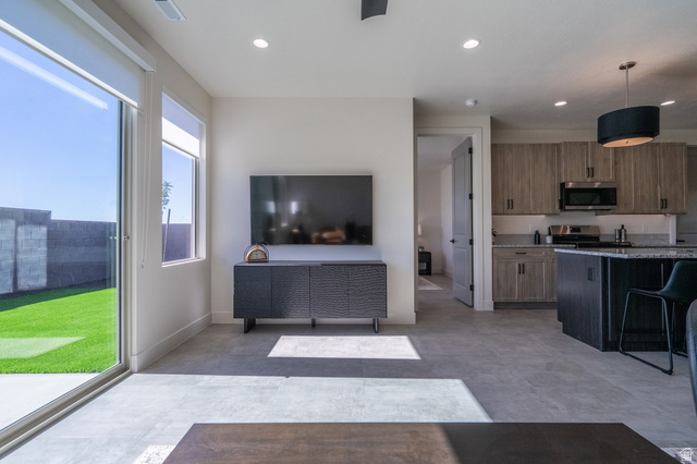 2972 West 570 North Hurricane, UT 84737 - Photo 34 of 104 Kitchen featuring hanging light fixtures, stainless steel appliances, light stone countertops, a kitchen breakfast bar, and wood finish cabinets