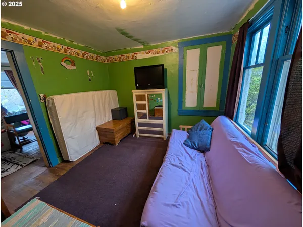 a bed room with furniture and a flat screen tv