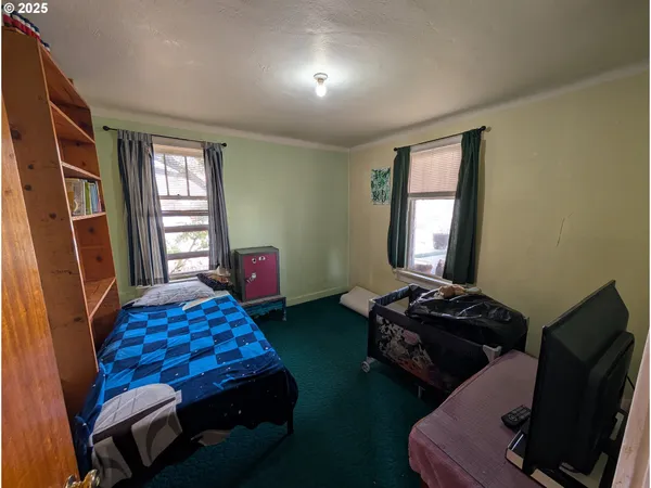 a bedroom with bed and a window