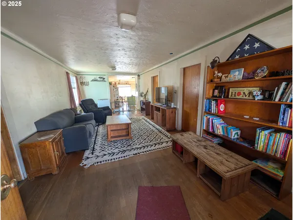 a living room with furniture and a book shelf