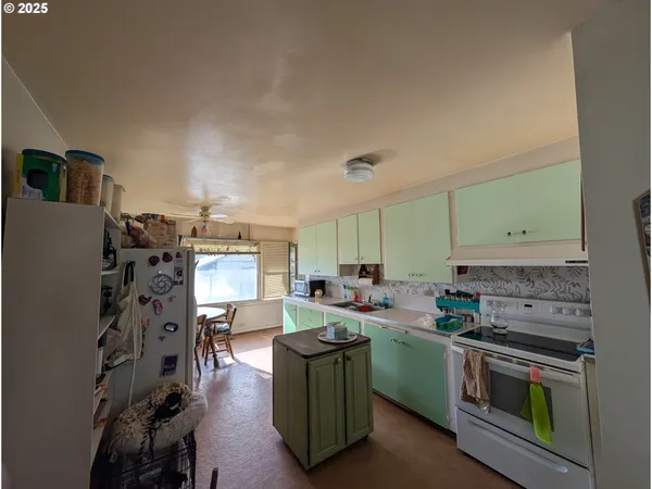 a kitchen with lots of counter top space appliances and furniture