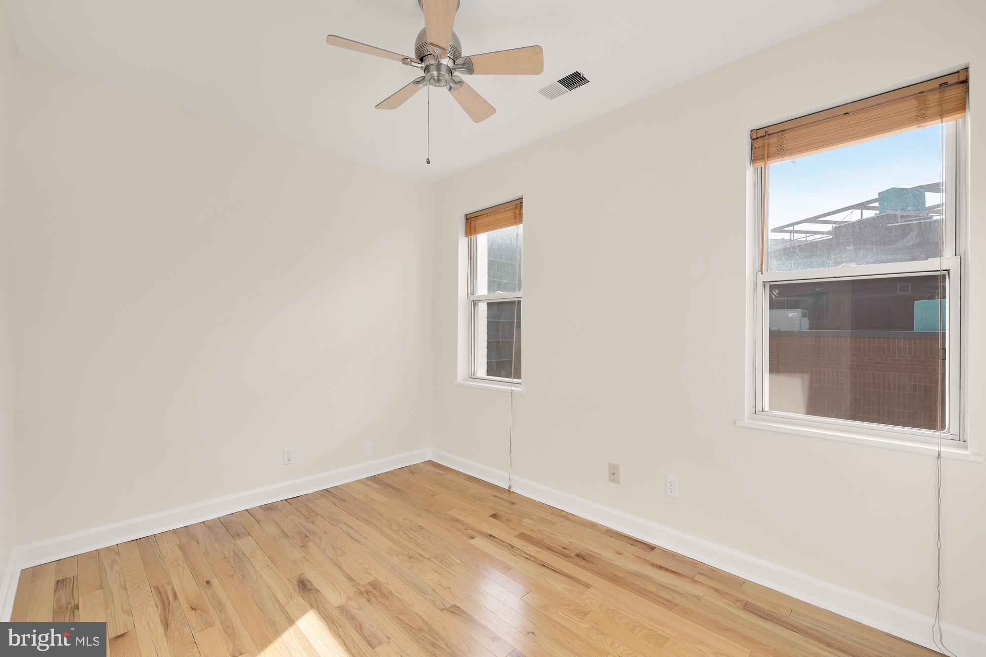 2114 N Street Northwest, Unit 47 Washington, DC 20037 - Photo 21 of 28 a view of empty room with wooden floor and fan