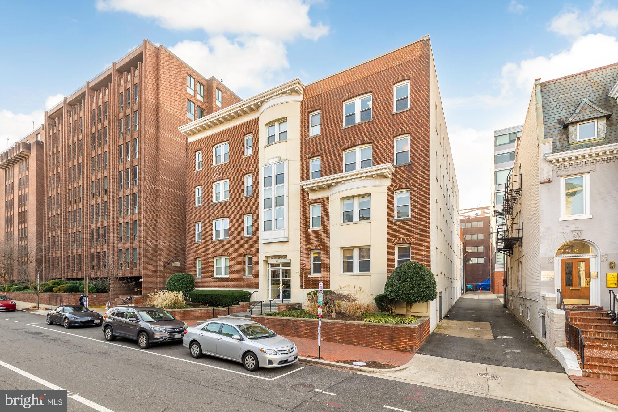 2114 N Street Northwest, Unit 47 Washington, DC 20037 - Photo 27 of 28 a city street lined with parked cars and buildings